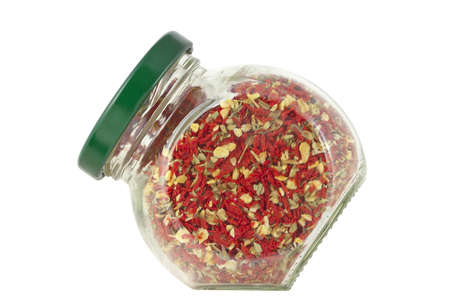 Sun-dried tomatoes with herbs in glass jar  の写真素材
