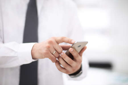 Mock up of a man holding device and touching screenの写真素材