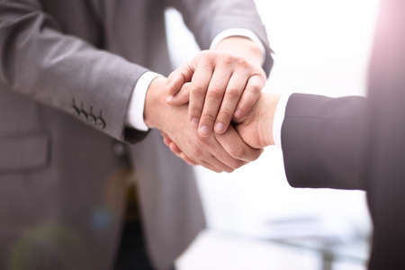 Close up view of business partnership handshake concept.Photo of two businessman handshaking process.Successful deal after great meeting.の写真素材