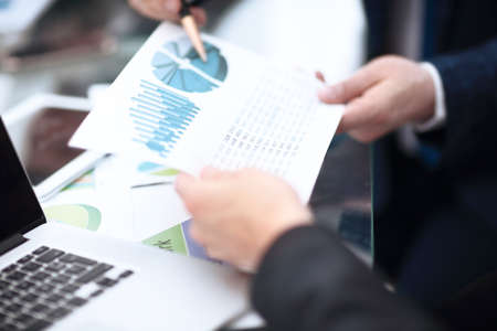 Image of business partners discussing documents and ideas at meetingの写真素材