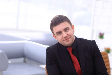Successful businessman posing and smiling at camera
