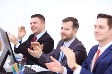 business, technology and office concept - happy business team with laptop computers, documents and coffee clapping handの写真素材