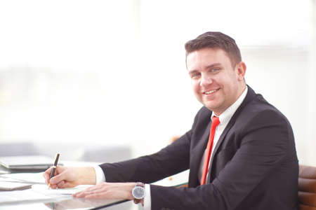 Successful businessman whith documents posing and smiling at cameraの写真素材