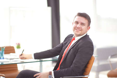 Successful businessman whith documents posing and smiling at cameraの写真素材