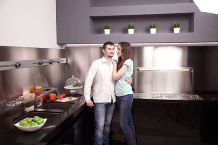 Portrait of happy young couple cooking together in the kitchen.の写真素材