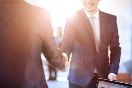 Two confident business man shaking hands during a meeting in office, success, dealing, greeting and partner concept.の写真素材