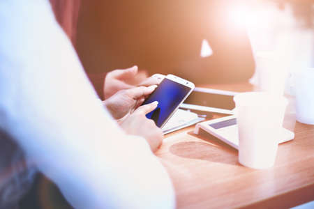 Close up of a man using mobile smart phoneの写真素材