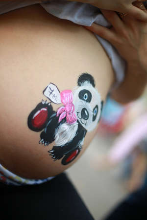 belly of a pregnant woman on a light backgroundの写真素材