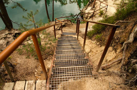 stairs leading down the glass path to the rock lake