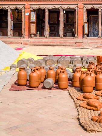 Pottery drying in the sun with rice and mandalas in the backgroundの写真素材