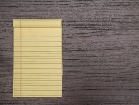 Dark Wood Desk, Yellow Notepad