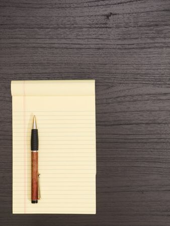 Wood Desk, Yellow Notepad,Ballpoint Penの写真素材