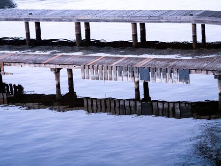 Wooden docks of old planks with reflections, landscape orientationの写真素材