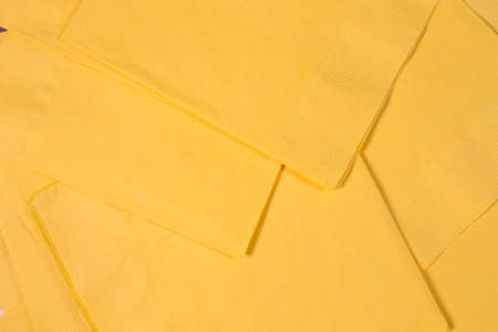 This is a photograph of Yellow paper napkins background