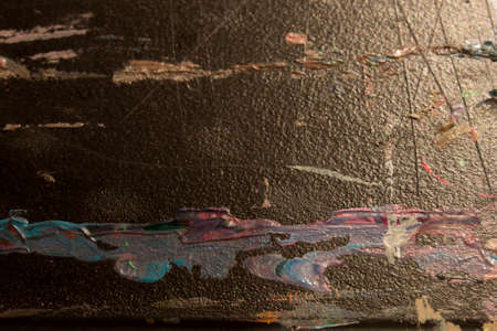This is a photograph of dried acrylic paint on a black tableの写真素材