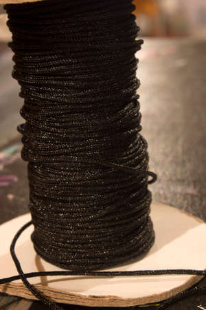 This is a photograph of a spool of Black thread