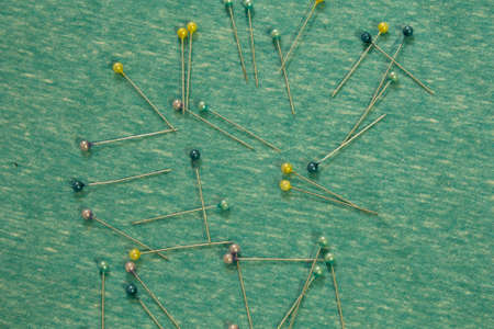 This is a photograph of sewing pins placed on fabricの写真素材