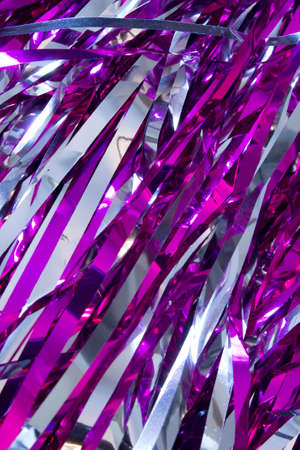 This is a closeup photograph of Cheerleader silver and purple pom pomsの写真素材