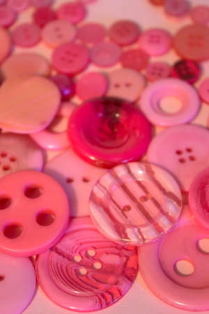 This is a photograph of Pink sewing buttons background