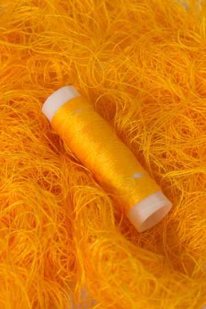 This is a photograph of a Neon Orange sewing thread roll background