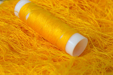 This is a photograph of a Neon Orange sewing thread roll background