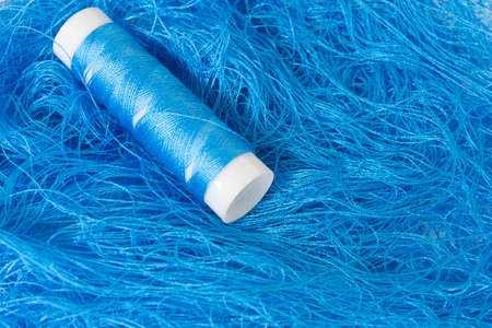 This is a photograph of a Neon Blue sewing thread roll background