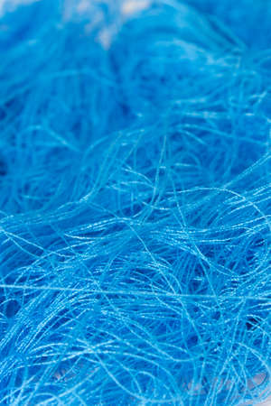 This is a photograph of a Neon Blue sewing thread roll backgroundの写真素材