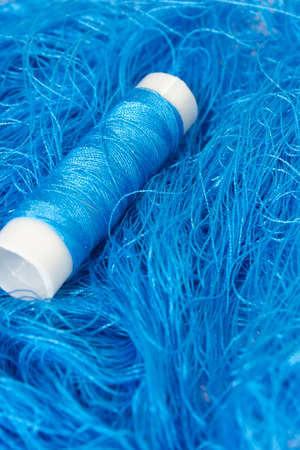 This is a photograph of a Neon Blue sewing thread roll background