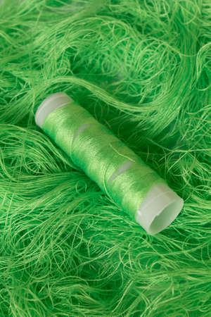 This is a photograph of Neon Green sewing thread roll background