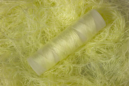 This is a photograph of Pastel Yellow sewing thread roll background