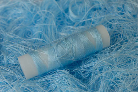 This is a photograph of Pastel Blue sewing thread roll backgroundの写真素材