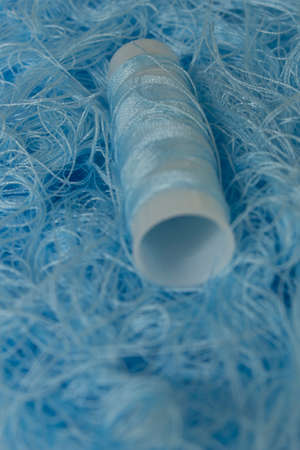 This is a photograph of Pastel Blue sewing thread roll backgroundの写真素材