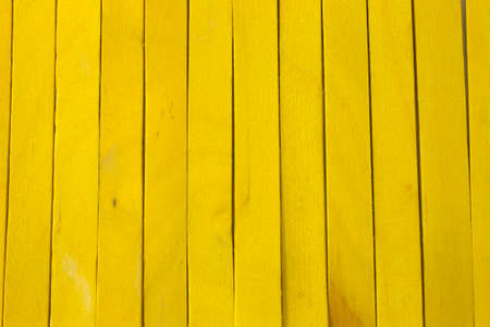 This is a photograph of Yellow colored popsicle sticks backgroundの写真素材