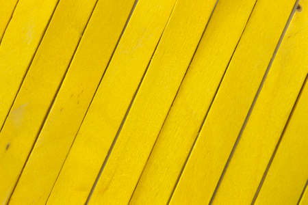 This is a photograph of Yellow colored popsicle sticks backgroundの写真素材