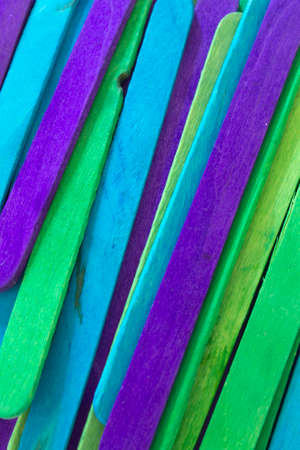 This is a photograph of Blue, Green and Purple colored popsicle sticks backgroundの写真素材