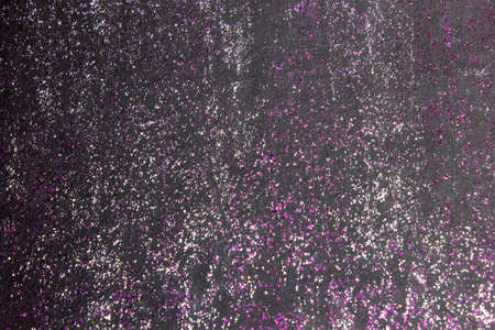 Purple and Silver Glitter paint on a Black backgroundの写真素材