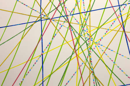 This is a photograph of a geometric background created using colourful tape and a white paper
