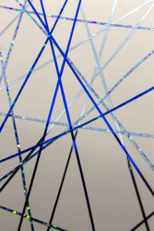 This is a photograph of a geometric design created using dark and light Blue tape applied onto a...