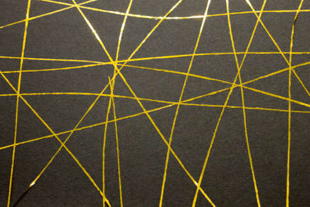 This is a photograph of a geometric design created using gold tape applied onto a Black paper