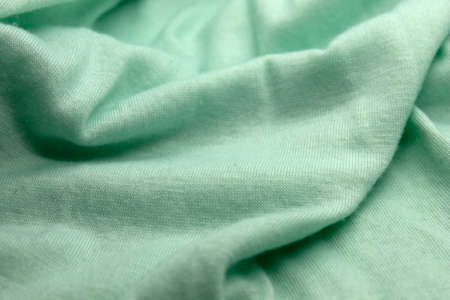 This is a photograph of a textured Green fabric backgroundの写真素材
