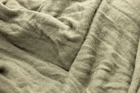 This is a photograph of textured Olive Green fabric backgroundの写真素材