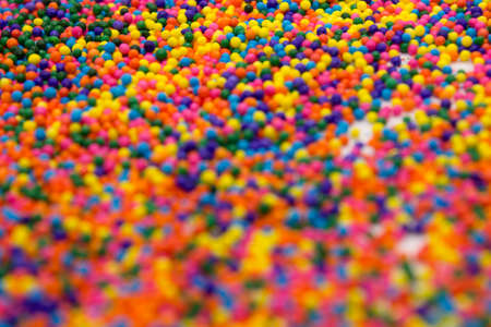This is a background of colorful neon colored round sprinkles backgroundの写真素材