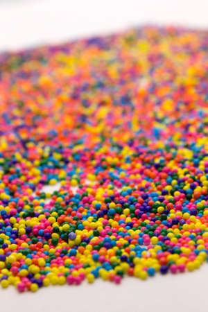 This is a background of colorful neon colored round sprinkles backgroundの写真素材