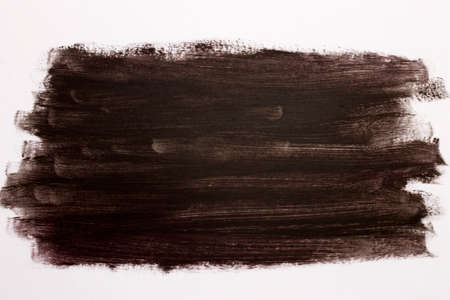 This is a photograph of a Dark Brown Lipstick swatch isolated on a White backgroundの写真素材