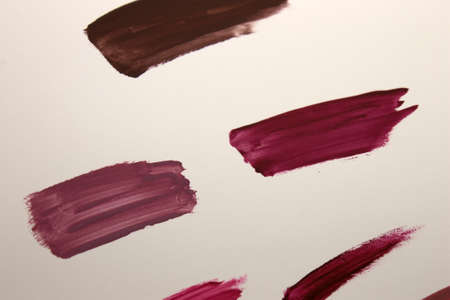 This is a photograph of Burgundy,Brown,Violet,Purple and Nude Lipstick swatches backgroundの写真素材