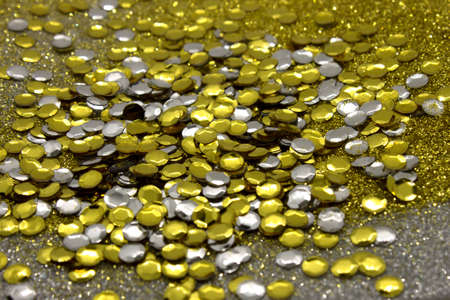Silver and Gold sequins on a glittery background