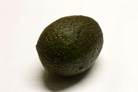 Avocado isolated on a White textured background with a dark shadow