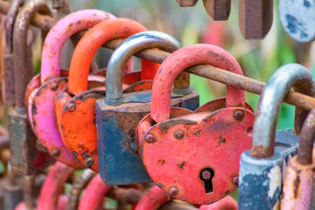 Group of old rusty locks closed during theier marriages as a symbol of eternal love and matrimonial promises.の写真素材