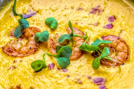 Tom yum soup with three shrimps on topの写真素材