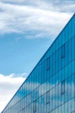 Scyscraper mirror facade devides the sky on two parts